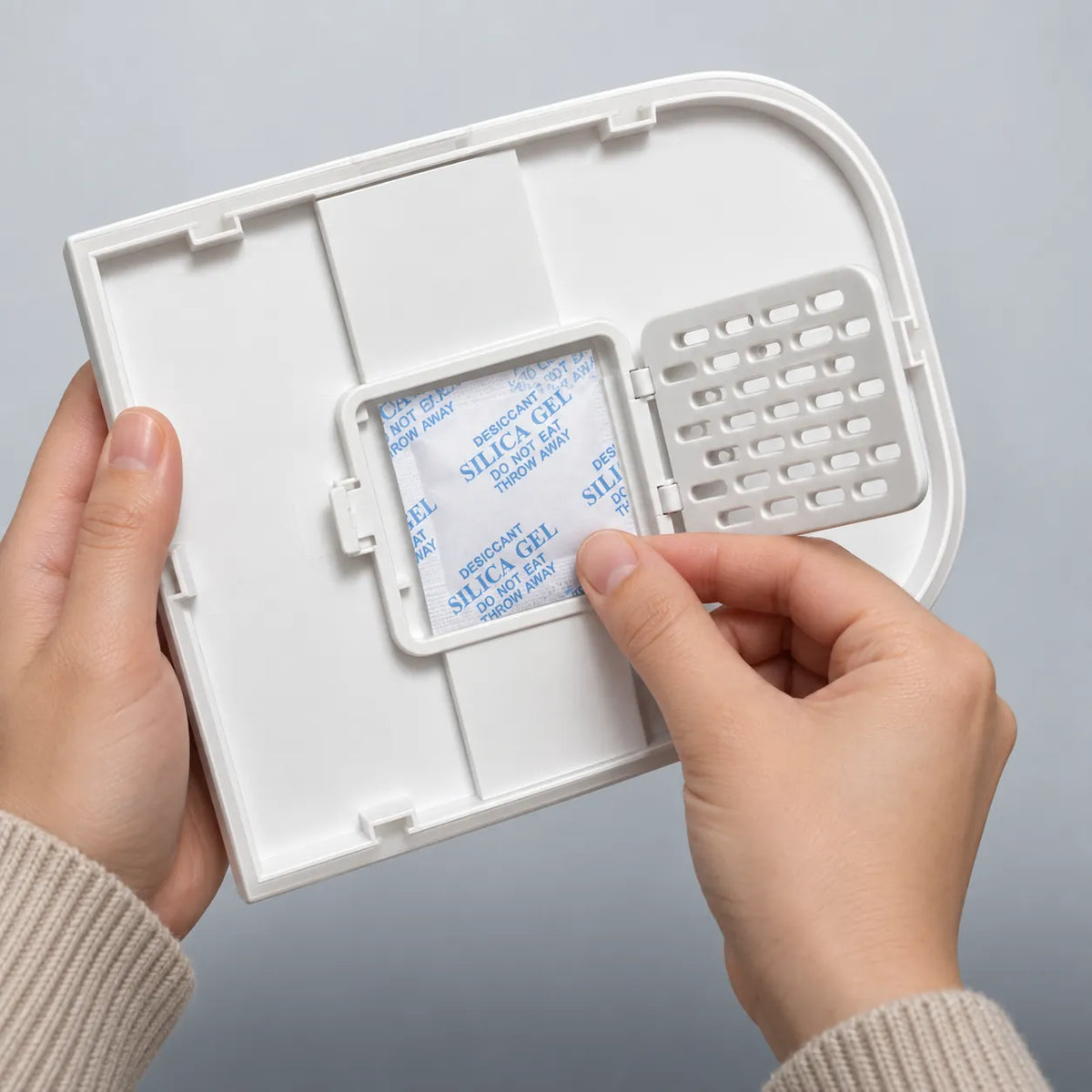 Unclipping the vented cover to add a desiccant sachet